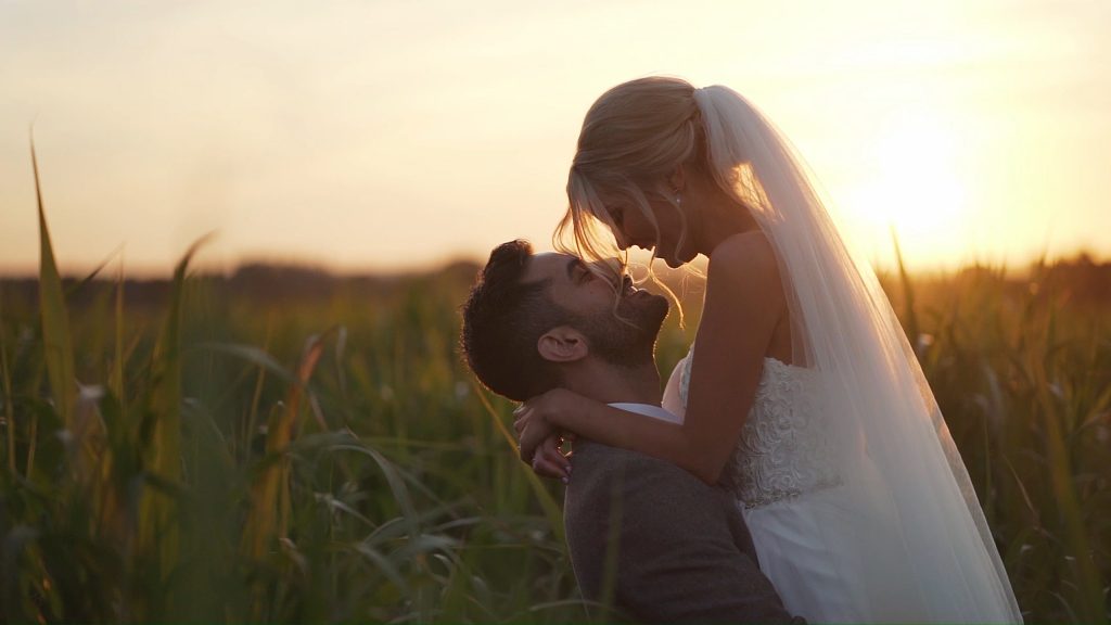 Dan lifting Sarah in a field of corn