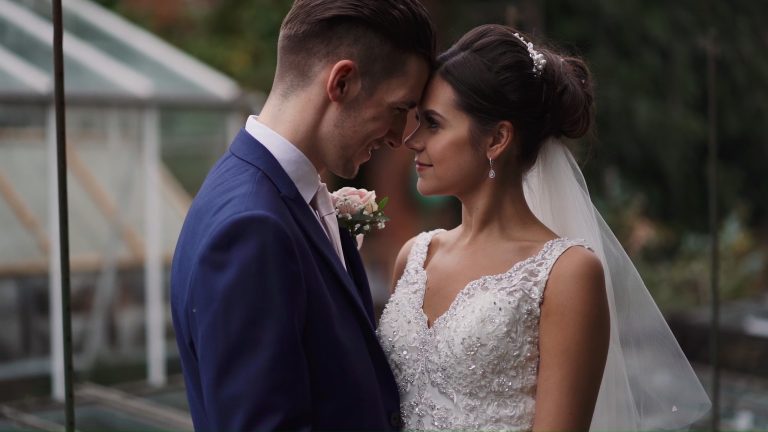 Groom and Bride resting their heads together in the gardens of Doddington Hall