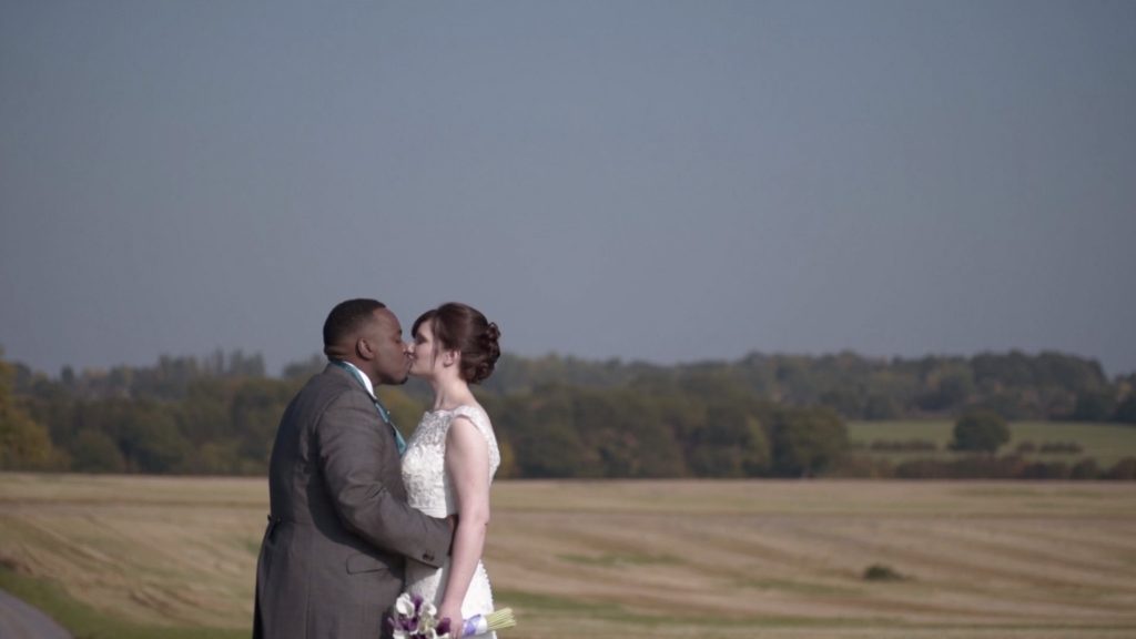 Swancar Farm Bride and Groom kissing in front of gorgeous corn fields