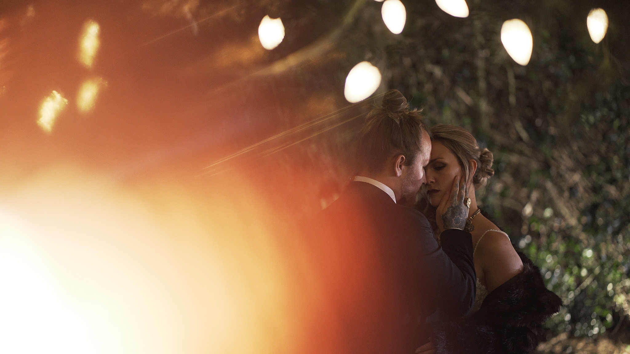 Bride and Groom under fairy lights at night time