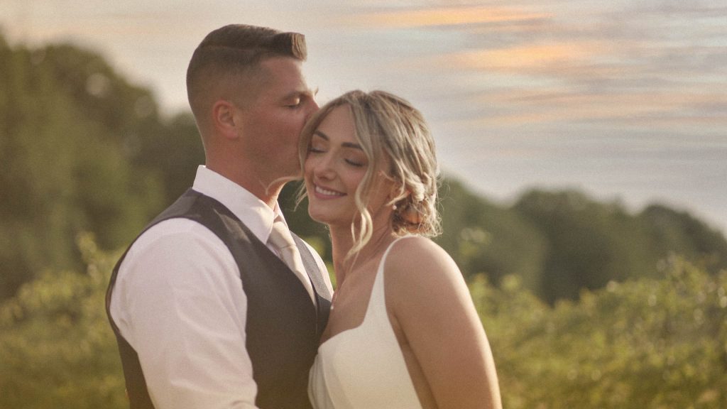 Couple Standing in front of fields at golden hour