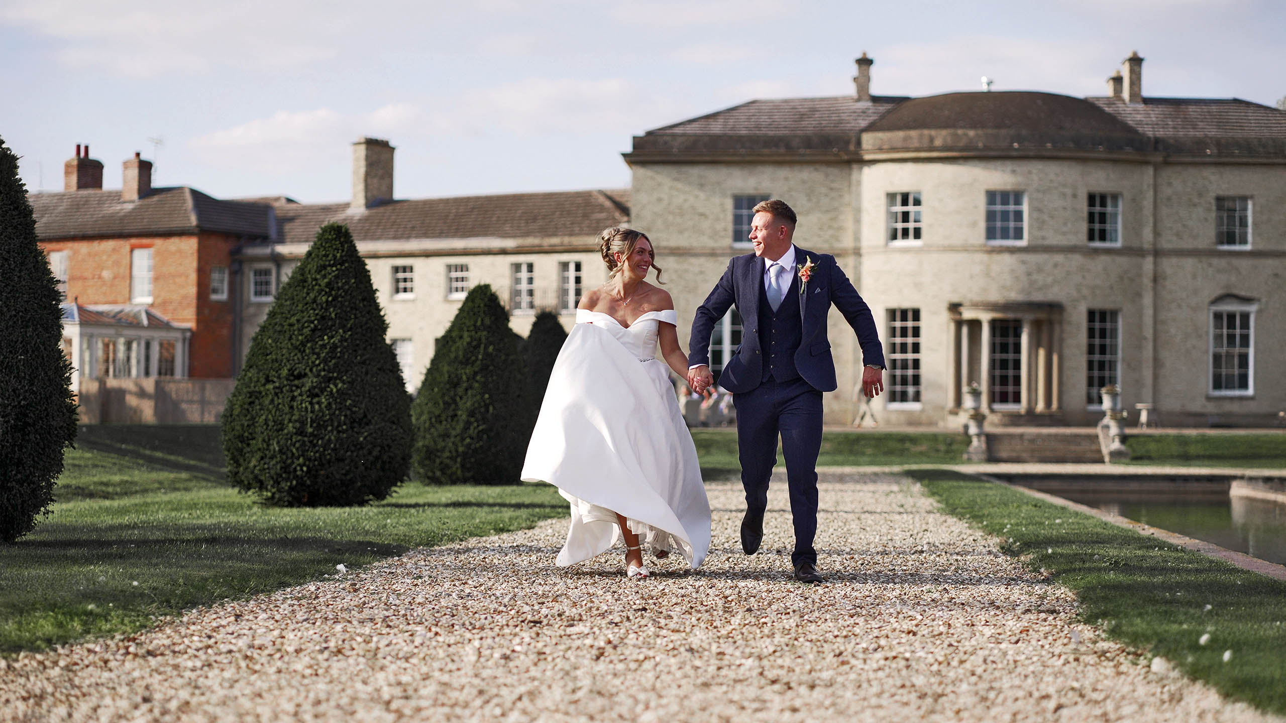 Newlyweds walking through an English estate