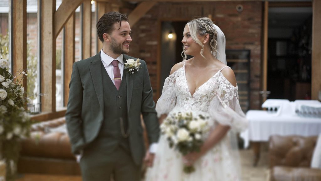 Bride and Groom exchange a glance at Swancar Farm