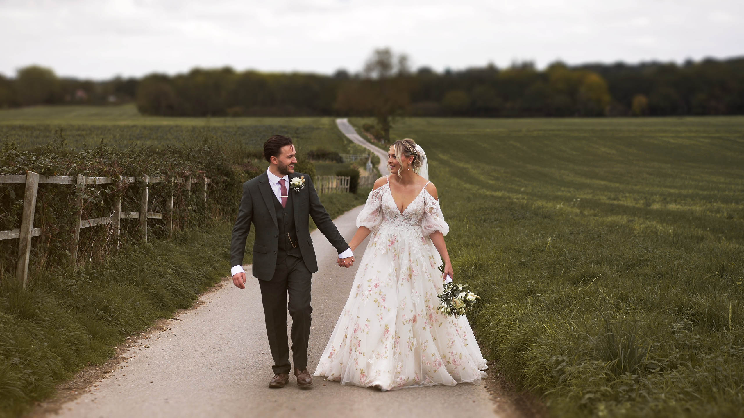 Bride and Groom together along the road leading to Swancar Farm wedding venue