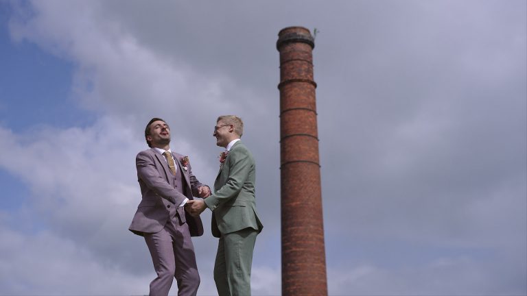 Two grooms together on their wedding day