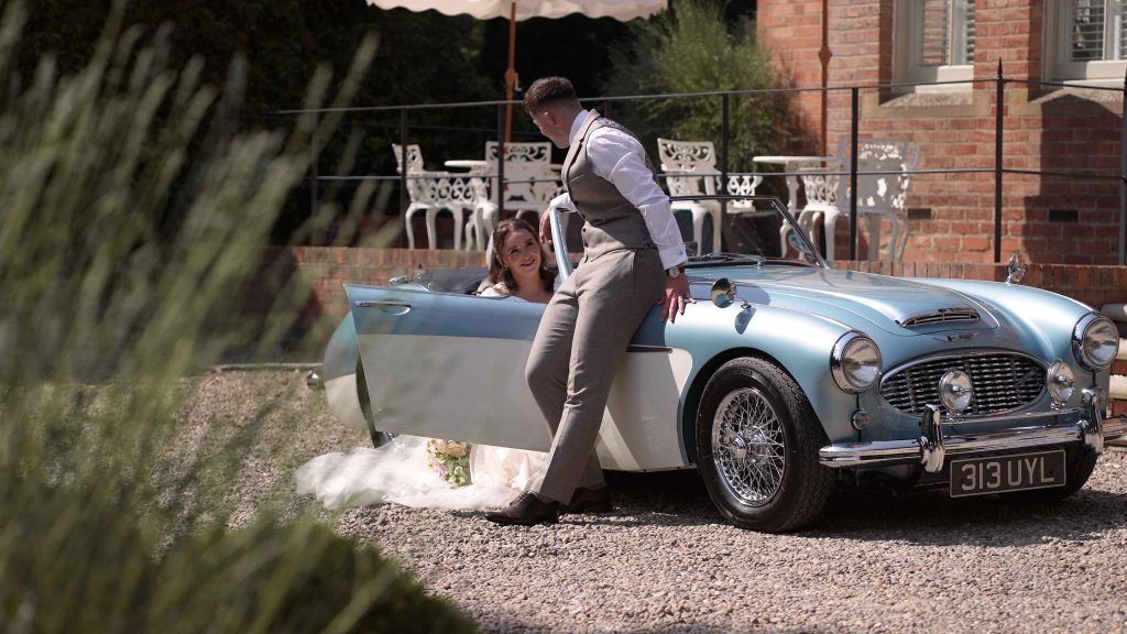 Bride and groom in vintage car